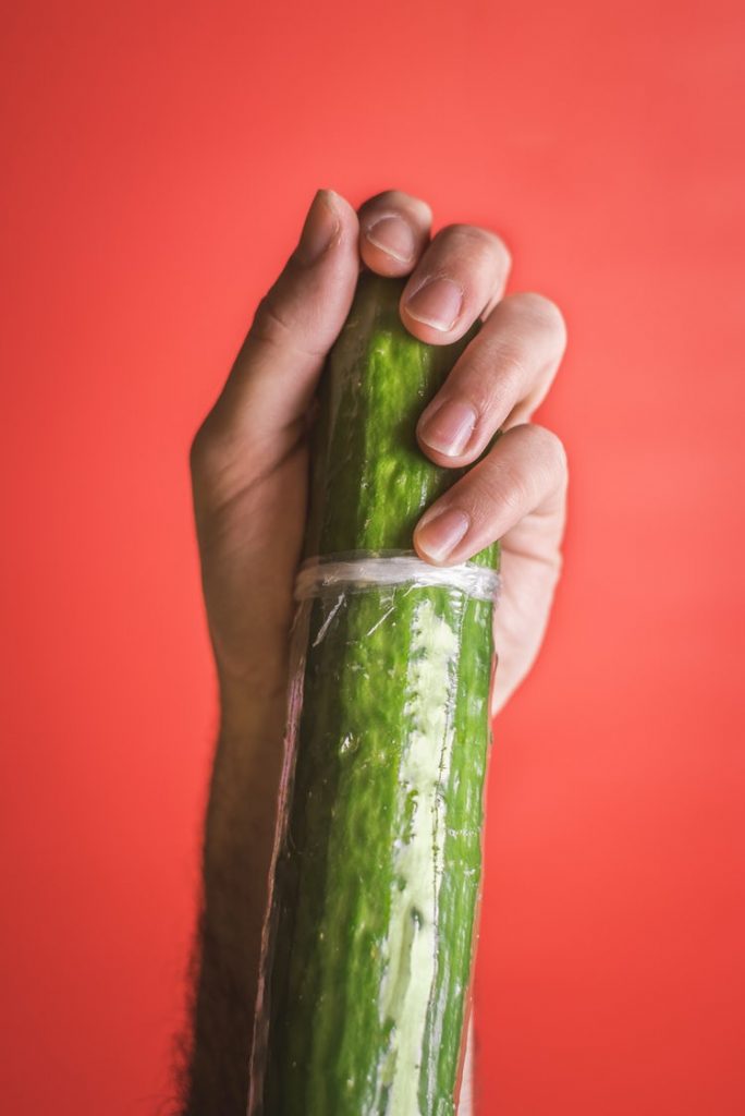 A cucumber and a hand on it - Penis Enlargement Surgery