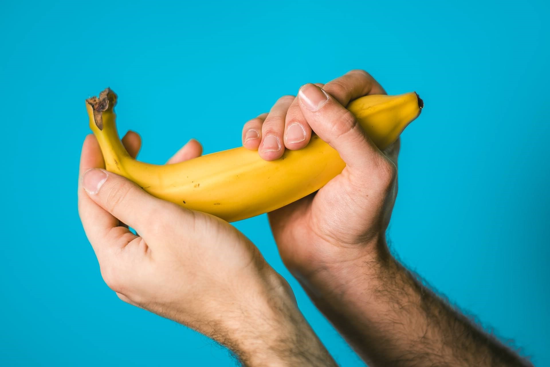 Man Holding Banana Referring to Penis Size